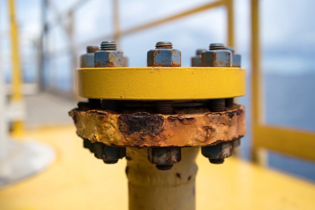 Corroded flange on pipeline shows the need for a reliable torque wrench to handle critical maintenance.